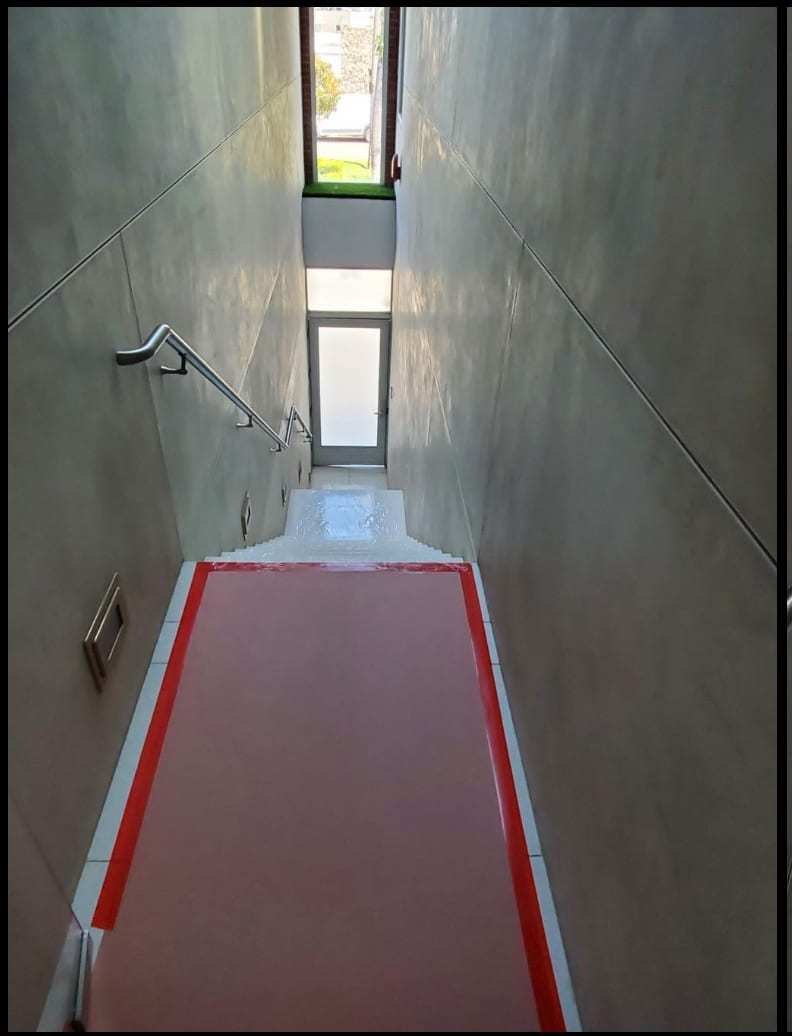 Stairwell with floor protection taped down during work