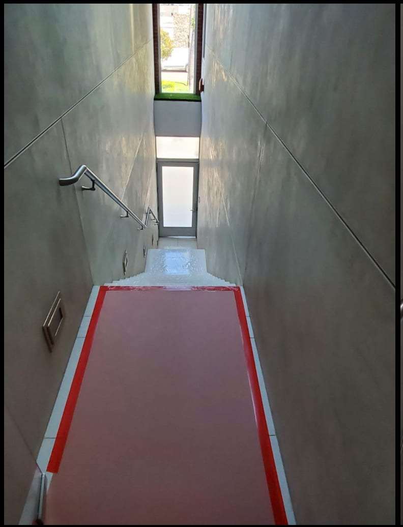 Stairwell with floor protection taped down during work
